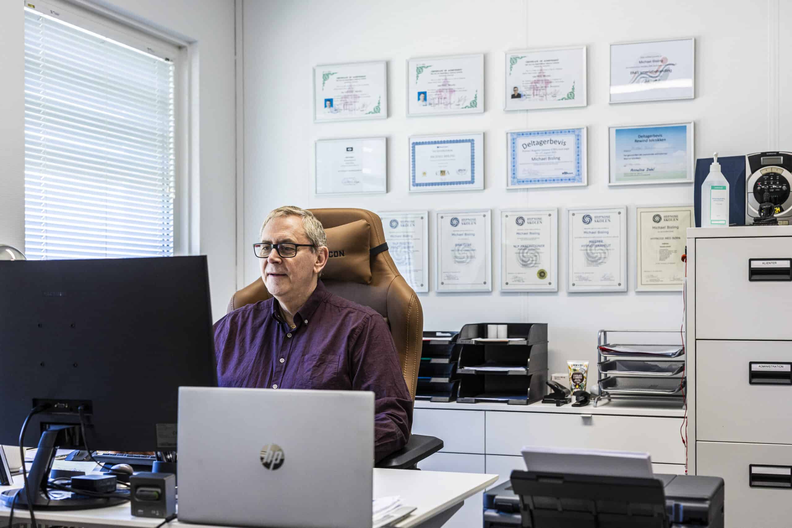 Hypnoterapeut arbejder ved skrivebord i klinik til hypnose angst hos Bisling Motivationsterapi